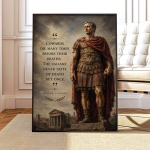 May include: A framed wall art print featuring a statue of Julius Caesar in Roman armor and a red cloak. The text reads: Cowards die many times before their deaths; The valiant never taste of death but once. Julius Caesar, with a laurel leaf icon.