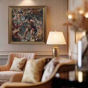 May include: An ornate framed painting depicting a classical scene with figures in shades of brown, red, and blue. A gold-colored lamp with a pleated lampshade sits on a table. A pink armchair with a decorative pillow is in the foreground.