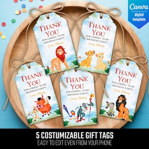 May include: Five customizable gift tags with a watercolor design featuring characters from The Lion King. Each tag has a "Thank You" message and is tied with twine. The tags are displayed on a wooden tray against a blue background.