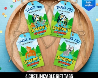 May include: Four colourful gift tags with the text "THANK YOU FOR CELEBRATING" and "JOSEPH'S 5TH BIRTHDAY WITH US!". Each tag features a different cartoon animal and is tied with twine. The tags are on a wooden tray.