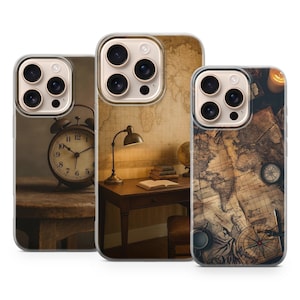 May include: Three phone cases with vintage-themed designs. One case features an alarm clock, another a desk with a lamp and books, and the third a world map with a compass. The cases have a clear border.