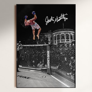 Puede incluir: Un póster enmarcado con una fotografía en blanco y negro de un luchador realizando un salto mortal hacia atrás dentro de una jaula octogonal. El luchador lleva guantes azules y pantalones cortos estampados. La Casa Blanca es visible al fondo y la firma de Justin Gaethje está impresa en tinta blanca en la parte superior derecha.