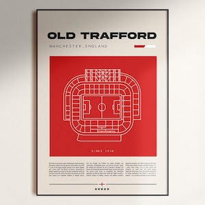 May include: A framed poster featuring a minimalist illustration of Old Trafford stadium in Manchester, England. The design includes a red background with a white outline of the stadium and the text "OLD TRAFFORD" and "SINCE 1910".