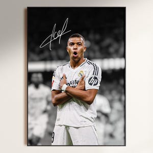 May include: Black and white poster featuring a soccer player in a white jersey with the Real Madrid logo and the HP logo. The player is crossing his arms and has an open mouth. The poster has a signature in the top left corner.