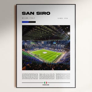 May include: A framed poster featuring the San Siro stadium in Milan, Italy. The image shows the stadium filled with spectators during a soccer match. Text at the top reads "SAN SIRO" and "MILAN, ITALY". The poster is framed in black.