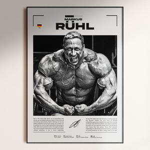 May include: Black and white framed poster featuring bodybuilder Markus R&uuml;hl. The poster displays a large image of R&uuml;hl flexing his muscles, with text including his name and biographical information. The German flag is visible in the upper left corner.