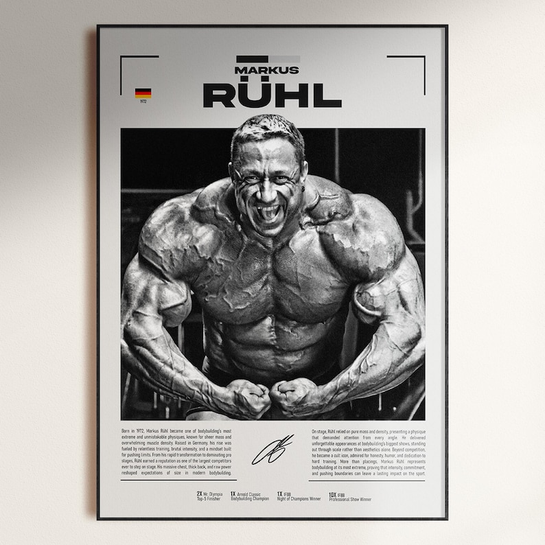 May include: Black and white framed poster featuring bodybuilder Markus R&uuml;hl. The poster displays a large image of R&uuml;hl flexing his muscles, with text including his name and biographical information. The German flag is visible in the upper left corner.