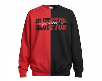 May include: A split-color crewneck sweatshirt featuring a red left side and a black right side. The chest displays the red glitter text "BLUFFTON" in a block font, with the white cursive word "pirates" layered horizontally across the center.