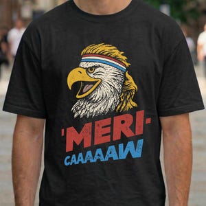 Distressed retro graphic featuring a bald eagle with a squawking open yellow beak and a blonde mullet haircut. The eagle wears a red, white, and blue striped athletic sweatband. Below the illustration, large weathered block text reads "'MERI-" in red, stacked above "CAAAAAW" in bright blue.