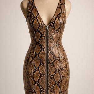 May include: A sleeveless dress with a snakeskin print. The dress has a V-neck and a full-length zip. It is displayed on a mannequin. The colour scheme includes shades of brown, tan, and black. The dress is designed to be form-fitting.