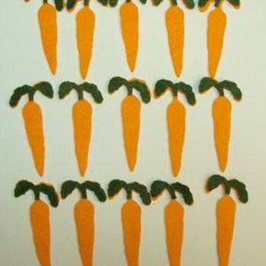 May include: A collection of orange felt carrots with green tops arranged on a white background. The carrots are in three rows, with each carrot having a simple, stylized design. The image is well-lit, highlighting the texture and color of the felt.