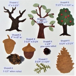 May include: A collection of felt shapes including trees, acorns, pine cones, and branches. The shapes are in various shades of brown, green, and tan. Measurements are provided in inches for each shape, such as a tree that is 4" x 3-1/3".