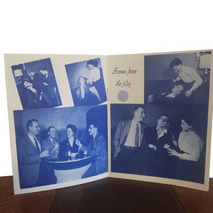 May include: A black and white photo booklet with scenes from a play. The booklet has a white background with blue text that reads "Scenes from the play". The photos show actors in various scenes from the play.