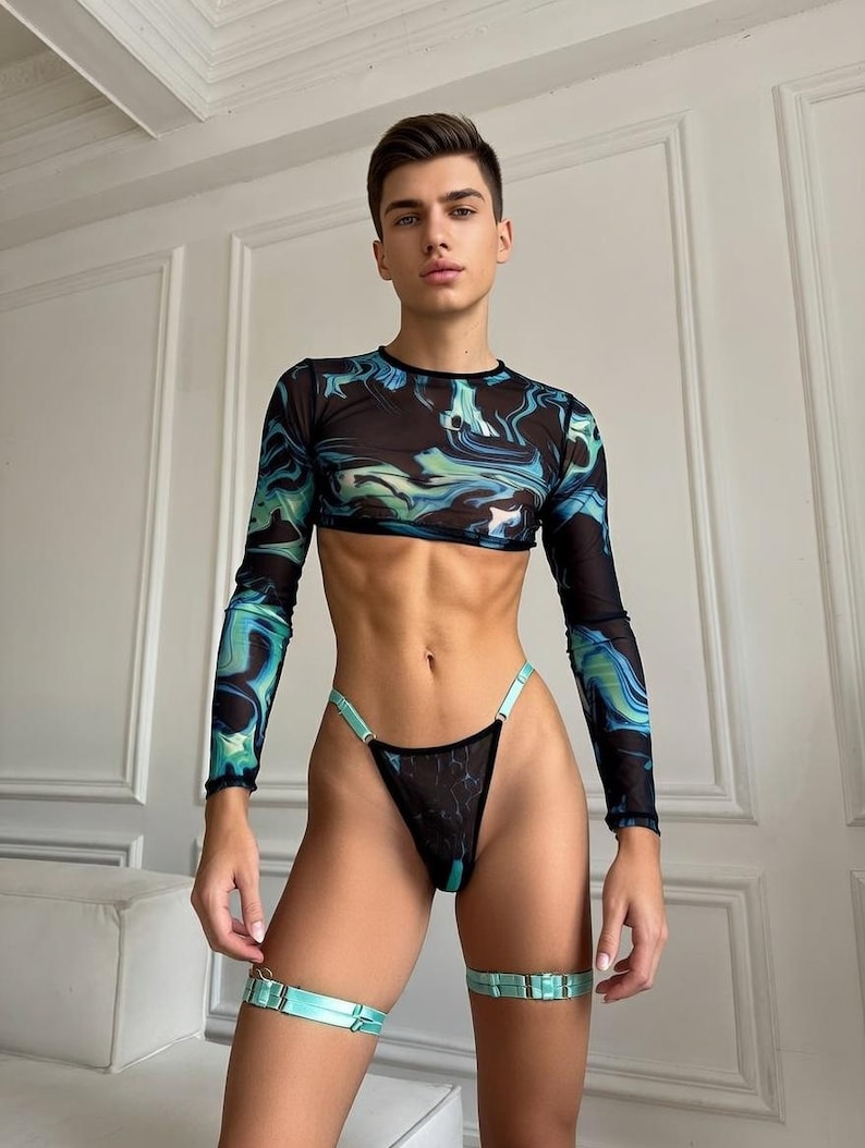 May include: A two-piece outfit featuring a long-sleeved crop top and matching thong underwear. The top and underwear are black with a blue and green marbled pattern. Light blue garter straps complete the look.