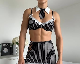 May include: A black and white striped lingerie set with a matching tie and collar. The set includes a bra, a mini skirt with lace trim, and fishnet stockings. The bra has white lace trim and small bows.