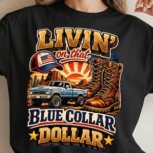 May include: Black t-shirt featuring a graphic with the text "LIVIN' on that BLUE COLLAR DOLLAR." The design includes a blue pickup truck, brown boots, a baseball cap with an American flag, and a desert landscape with a setting sun.