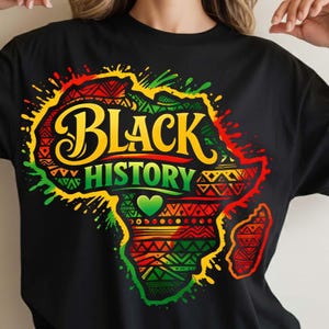 May include: Black t-shirt featuring a colorful graphic of the African continent with the words "BLACK HISTORY" in yellow and green. The design includes red, green, and orange patterns and a green heart.