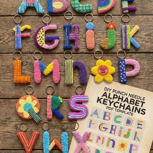 May include: A collection of colorful, handmade alphabet keychains, each letter uniquely designed with various patterns and colors. The keychains are displayed on a wooden surface, alongside a PDF template with instructions and a materials list for DIY punch needle alphabet keychains.