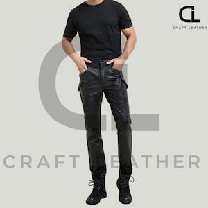 May include: Black leather pants with cargo pockets and a matching black t-shirt. The pants have a tailored fit and are paired with black boots. The Craft Leather logo is visible in the upper right corner.
