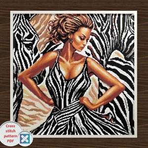 May include: A cross-stitch pattern PDF featuring a woman in a zebra-striped dress, set against a backdrop of zebra stripes. The artwork is framed in white, with a circular logo in the lower left corner.