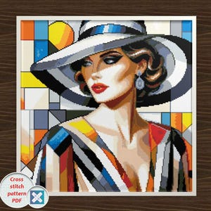 May include: Cross-stitch pattern PDF of a woman in a hat. The artwork features a woman with red lips and a white hat with a black and blue band. The woman is wearing a colourful striped top. The background is geometric.
