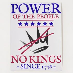 May include: White poster with the text "POWER OF THE PEOPLE" in blue, "NO KINGS" in red, and "- SINCE 1776 -" in blue. A black crown is crossed out with red lines, and there are five blue stars.