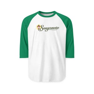 May include: White and green baseball style shirt with the word "Sangermeño" in a script font. The shirt has green sleeves and a green neckline. The text is in a cursive font with a yellow lamp graphic.