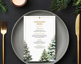Könnte beinhalten: Eine Weihnachtskarte mit goldenem Rand, platziert auf einem grauen Teller mit goldenem Besteck. Die Speisekarte umfasst Vorspeisen, Hauptgerichte, Beilagen und Desserts. Auf der Karte befinden sich Weihnachtsbäume.