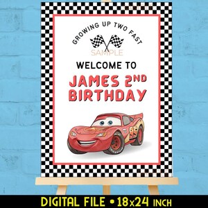 May include: A birthday party sign featuring a red race car illustration. The sign reads "Growing Up Two Fast" and "Welcome to James 2nd Birthday." The sign is 18x24 inches and has a black and white checkered border.