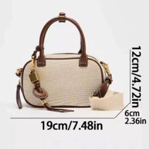 May include: A beige and brown handbag with a top handle and a detachable shoulder strap. The bag is 19cm long, 12cm high, and 6cm wide. It features a brown leather handle and trim, a gold-coloured clasp, and a decorative tassel.