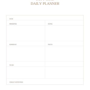 May include: A white daily planner with the text "SOFT GIRL DAILY PLANNER" in a light brown font. The planner includes sections for date, priorities, notes, schedule, focus, to-do, and today's intention.