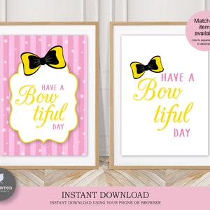 May include: Two printable signs with a pink and white striped background. The signs feature a yellow bow with a black center and the text "Have a Bow-tiful Day".