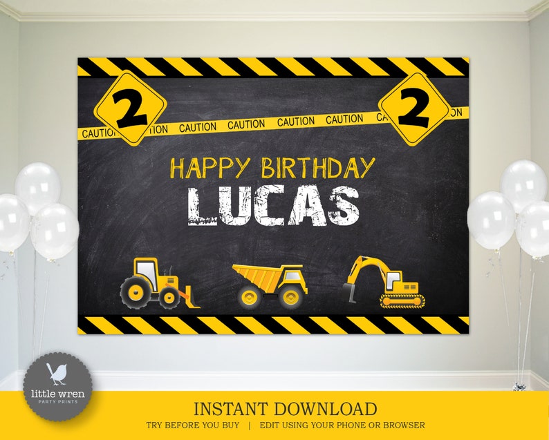 May include: A black chalkboard backdrop with yellow and black caution tape border. The text "HAPPY BIRTHDAY LUCAS" is written in white chalk. There are three yellow construction vehicles on the backdrop. The numbers "2" are on yellow diamond signs on either side of the backdrop.