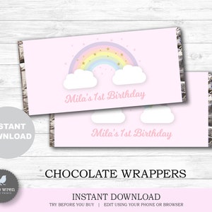 May include: Printable chocolate bar wrappers with a rainbow, clouds, and gold stars on a pink background. The text "Mila's 1st Birthday" is printed on the wrappers.