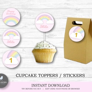 May include: Printable cupcake toppers and stickers featuring a rainbow, clouds, and the text "Happy Birthday" and "Mila". The toppers are pink with gold accents. There is also a brown paper bag with a rainbow sticker that says "1".