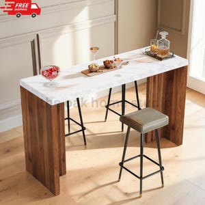 May include: A rectangular bar table with a white marble-patterned top and thick wooden legs, accompanied by a stool with a gray seat and black metal frame. On the table are a glass bowl with red items, a wooden board with snacks, and a glass decanter.