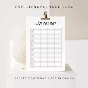 May include: A white paper calendar for January 2026, held by a metal clip. The calendar has a grid layout with numbered days and the word "Januar" at the top. The text "FAMILIENKALENDER 2026" is at the top. The words "SOFORT-DOWNLOAD | PDF IN DIN A4" are at the bottom.