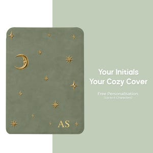 Sage green celestial Kindle cover personalized with gold initials, featuring an embossed moon and scattered star design on the front.