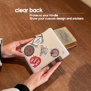May include: A clear protective case for a Kindle e-reader, featuring a variety of colorful stickers on the back. The text on the image reads: clear back, Protects your Kindle, Show your custom design and stickers.