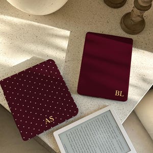 May include: A set of three ceramic mugs with a speckled, matte finish. The mugs are in cream, light grey, and dark grey. Each mug has a simple, minimalist design, ideal for coffee or tea.