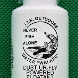 May include: A white bottle with a black cap, labeled "J.T.K. Outdoors" and "Water Walker" for fly fishing. The bottle contains a "Dust-Ur-Fly Powered Floatant Brush" and is made in the USA.