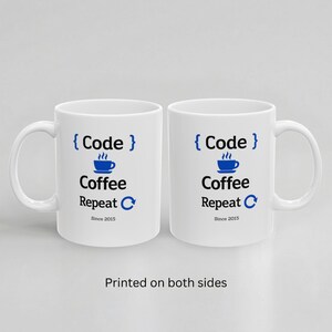 Two white ceramic mugs displayed side by side with handles on opposite sides, both showing the same “Code Coffee Repeat” design and “Since 2015” personalization to demonstrate double-sided printing.