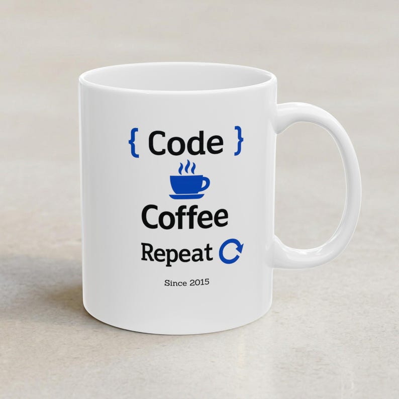 White ceramic mug with the “Code Coffee Repeat” design in black and cobalt blue, featuring the personalized text “Since 2015” below. Front-facing product photo on a light neutral background.