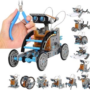 May include: A gray and blue solar-powered robot kit with multiple build options. The main robot has a rectangular body, large wheels, and a head with two blue lights. A hand holds blue wire cutters. Additional robot models are shown.