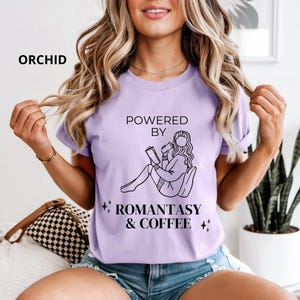 May include: A white ceramic mug with a black handle and the text "But First, Coffee" in a bold, black font. The mug is set against a blurred background, suggesting a cozy setting.