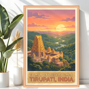 May include: A framed travel poster featuring the Tirumala Venkateswara Temple in Tirupati, India. The artwork depicts the temple in gold tones, set against a backdrop of green hills, a winding river, and a sunset sky. The poster includes the text "Tirumala Venkateswara Temple, Tirupati, India."