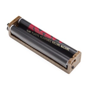 May include: A brown hemp plastic adjustable rolling machine with a black roller belt. The belt features red branding and the text HEMP PLASTIC ADJUSTABLE ROLLING MACHINE printed in gold lettering across the center of the device.