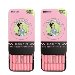 May include: Two pink and black boxes of pre-rolled filter tips. Each box features the text "Blazy Tips" and a circular graphic with a woman in a blue uniform. The boxes also display the text "100 Tips Per TM" and "Ready to Use".