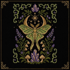 May include: A cross-stitch pattern on a black background featuring a central green moth with a golden crescent moon and star above it. The design includes purple crystal clusters, green vines, lavender sprigs, lily of the valley, and mushrooms.