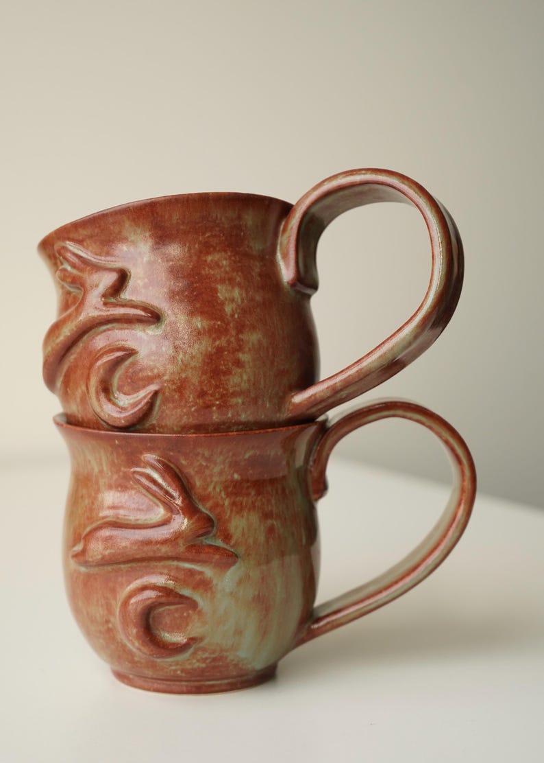 handmade ceramic bunny jumping over the moon woody space mug image 2
